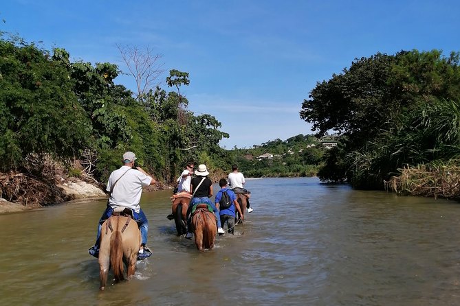 Los Naranjos Beach Horseback Riding Tayrona Park. - Riding along the Piedras River