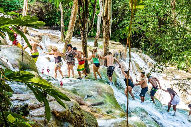 Zipline, Dunn’s River Falls, Bamboo Rafting & Horseback Ride Tour - Ziplining above the waterfalls